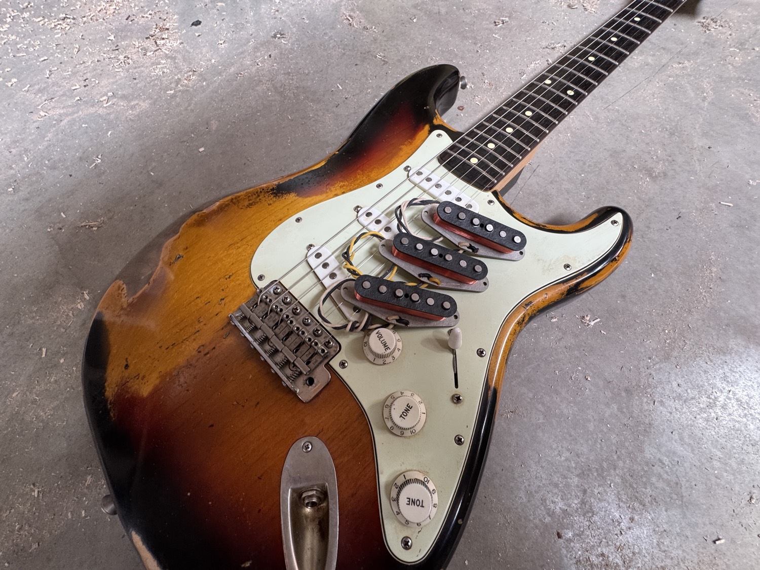 A Bellwether pickup held in the hand, showing staggered pole pieces